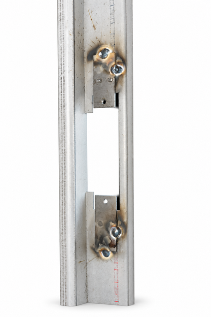 Strike cutout with welded reinforcement tabs on a steel frame jamb